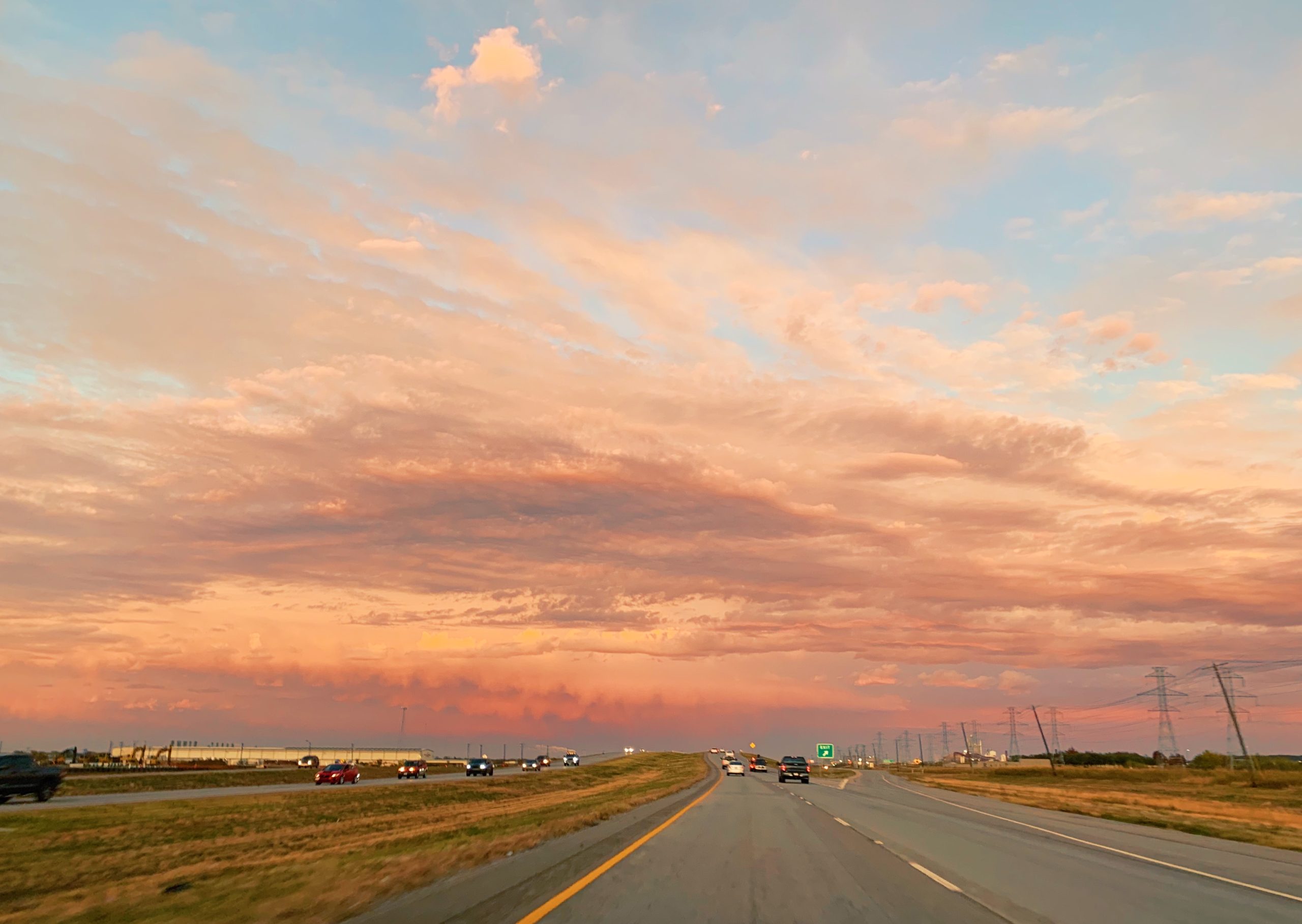 pink sunset on the  texas highway wide open fields